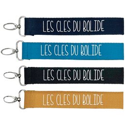 A set of four key rings in navy blue, teal, black, and gold, each with the text "LES CLES DU BOLIDE" printed on them. These key rings are designed for holding car keys or other small items.