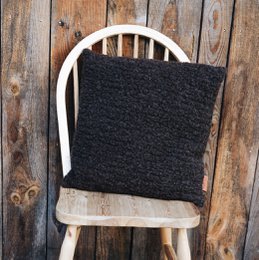 Bi-material Happy Cushion, a cozy cushion with a combination of faux fur and patterned fabric, available in multiple color variants.