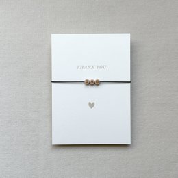 Handmade minimalist thank you card with a simple heart design and beads. Suitable for a variety of occasions.
