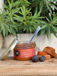 Creamy pepper spread in a glass jar with a gold lid. The spread is a vibrant orange-red color and appears to have a smooth, spreadable texture. The label indicates this is a "Creme de Piments" or pepper cream product.