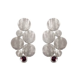 Silver statement earrings with round discs and burgundy gemstone accents.