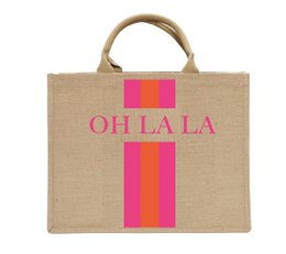 Beige jute beach bag with bold pink and orange vertical stripes, featuring the text "OH LA LA" in pink. The bag has sturdy handles and appears to be a stylish and practical accessory for carrying items to the beach or for everyday use.