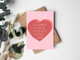 "Feminist postcard with heart-shaped design and empowering message for Valentine's Day"
This Valentine's Day card features a bold, heart-shaped design in red against a pink background. The text on the card reads "If you wanna be my lover, you gotta get with my feminist agenda", conveying a message of empowerment and gender equality. The card is suitable for those looking to celebrate Valentine's Day with a touch of feminist flair.