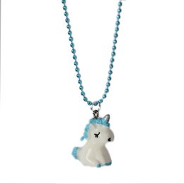 A children's necklace with a blue and white unicorn pendant on a beaded chain.