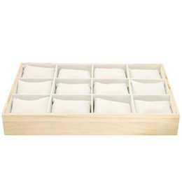 A wooden display tray with 12 compartments, designed to showcase and organize bracelets or other small jewelry items.