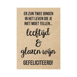 A birthday card with a humorous Dutch text that translates to "There are two things in life you should not count: age and glasses of wine. Congratulations!" The card has a rustic, kraft paper background with black text and a simple circular logo design.