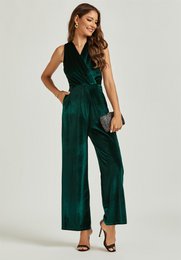  A sleeveless, emerald green velvet jumpsuit with a wrap-style top and wide-leg pants. Suitable for formal or evening wear.