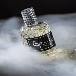 Men's perfume in a glass bottle with a crystal-encrusted cap, part of the GT collection. Eau de parfum fragrance.
