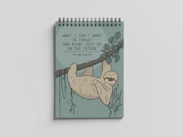 A5 size spiral-bound notepad with a sloth design on the cover and lined pages inside, suitable for to-do lists and note-taking.