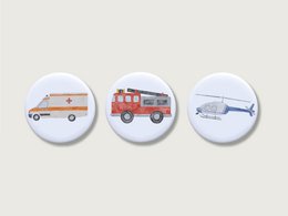 Set of 3 magnets featuring emergency vehicles including a police car, fire truck, and airplane. Suitable for children, these magnets are perfect for decorating refrigerators or other magnetic surfaces.