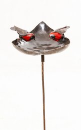 Metal heart-shaped bird feeder on a stick with red accents.