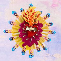 A vibrant, abstract relief image featuring a central red and yellow flower surrounded by blue and yellow shapes, creating a striking and dynamic visual composition.