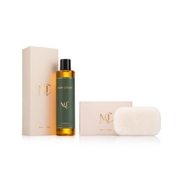 Luxury spa gift set with amber glass bottle, natural skincare, cream packaging, botanical ingredients.