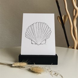 Scallop-shaped postcard with a simple, elegant design.