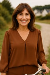 A long-sleeved, V-neck tunic in a warm brown color with a flowing, contemporary style.