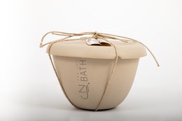 Seaweed sea salt bath in a round, beige container with a lid. The container has the text "Seaweed" printed on it.