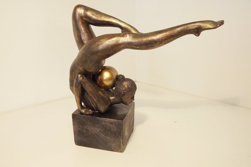 Gymnast with gold ball on her neck