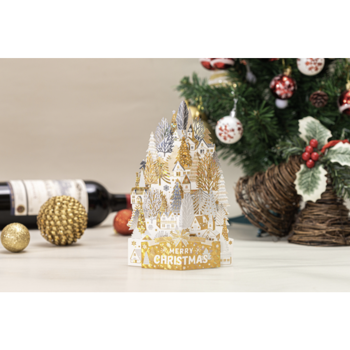 3D Pop-up-Weihnachtskarte goldweiße Häuser auf einem Schneehügel