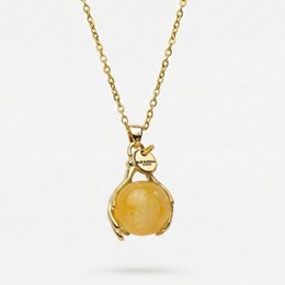 A gold-colored necklace with a yellow jade pendant in the shape of hands, representing self-sufficiency. The necklace is part of the Chains category.