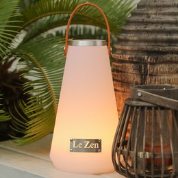 Tall, cylindrical table lamp with a soft, warm glow and a leather handle for easy portability. Features the "Le Zen" brand name.
