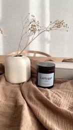 Tall, round white candle with a floral scent. Comes in a variety of scents to awaken the soul, create a cozy home, and inspire the spirit.