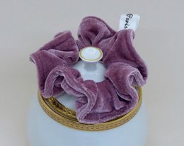 Soft, plush, old pink scrunchie with a decorative button detail.