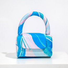 A stylish, travel-friendly handbag in a vibrant blue and pink marble pattern. Made of durable materials, this versatile bag is perfect for everyday use or weekend getaways.