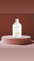 Collagen supplement in a white bottle with gold accents. The bottle is displayed on a pink pedestal against a gold glitter background.