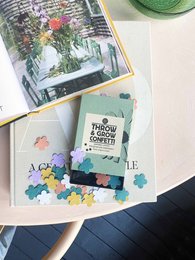 Colorful confetti mix in a box, perfect for party decorations and celebrations.
