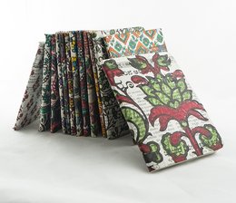 Notebook made from recycled newspapers and papers, featuring a printed protea flower design in a vibrant, colorful pattern.