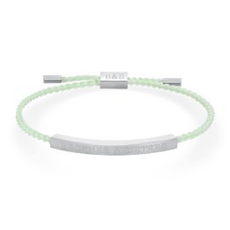 Delicate woven bracelet in light green color, featuring a thin metal bar accent. Suitable for casual or formal wear.