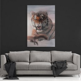 This canvas print features a close-up portrait of a fierce tiger with its mouth open, revealing sharp teeth. The tiger's intense gaze and powerful expression make this an eye-catching and dramatic piece of wall art.