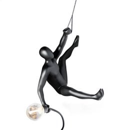 A modern, black wall light fixture in the shape of a climbing figure, with an adjustable arm and light bulb.