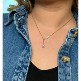 Gold-plated necklace with a single pearl pendant on a delicate chain.