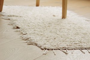 Klein crèmekleurig katoenen vloerkleed van 100/50 cm