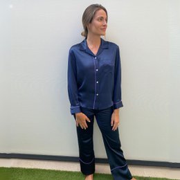 Navy blue silk pajama set with long sleeves and button-down closure.