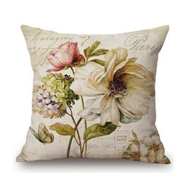 A decorative throw pillow featuring a vintage-inspired floral design with a pink and white flower against a script background. The pillow has a neutral color palette and would complement a variety of home decor styles.