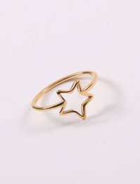 Gold star-shaped ring with a simple, minimalist design.