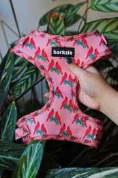 Vibrant pink and white floral pattern dog harness with adjustable neck and chest straps for a comfortable and secure fit.