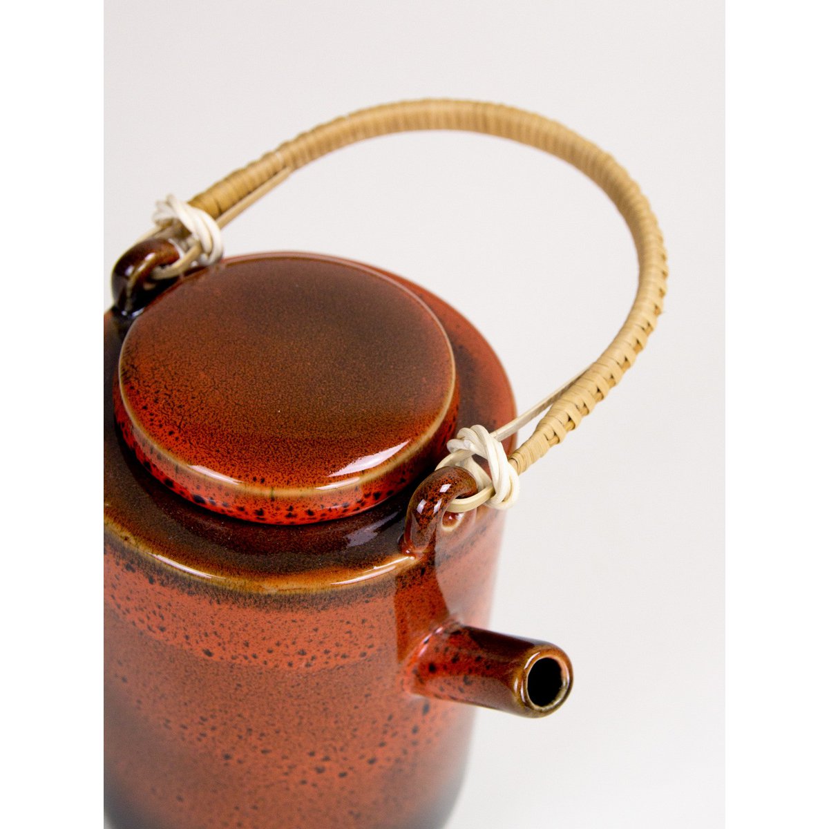 Laterite teapot by Hoa Bien with rattan handle