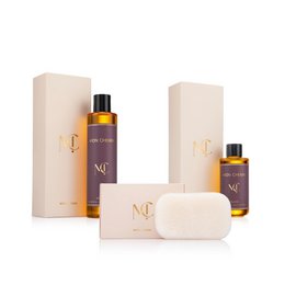 Luxury beauty gift set with purple bottles, soap bar, beige packaging, golden oil, skincare collection.