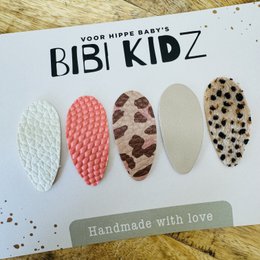 Set of 4 hair clips in various sizes and animal print designs. Handmade hair accessories for kids.