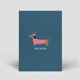 Dachshund Christmas card with fair, ecological, and sustainable materials. Illustrated dachshund dog in festive colors on a navy blue background.