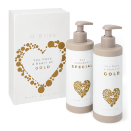  This hand giftset includes a "Heart of Gold" and "Somebody Special" product, both featuring a heart-shaped design made of gold-colored elements. The set is suitable for beauty and personal care purposes.