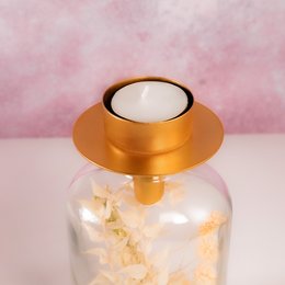 Elegant gold-toned tea light holder with a simple, modern design. Made of high-quality materials for a luxurious look and feel.