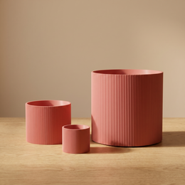 Cylindrical ridged 3D printed planter, matte finish, multiple sizes and colors including pink, black, green, white, gray.