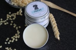 Unscented natural dog paw and nose balm in a round tin container. Made with moisturizing ingredients to soothe and protect paws and noses.