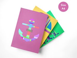 A set of 3 colorful A6 size travel notebooks featuring an anchor, hot air balloon, and "Fly With Me!" designs in pink, yellow, and green.