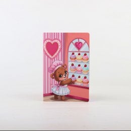 A pink notebook with a teddy bear design, suitable for children.