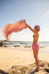 Large, soft, absorbent beach towel in a variety of colors including pink, blue, green, and grey. Ideal for relaxing on the sand.